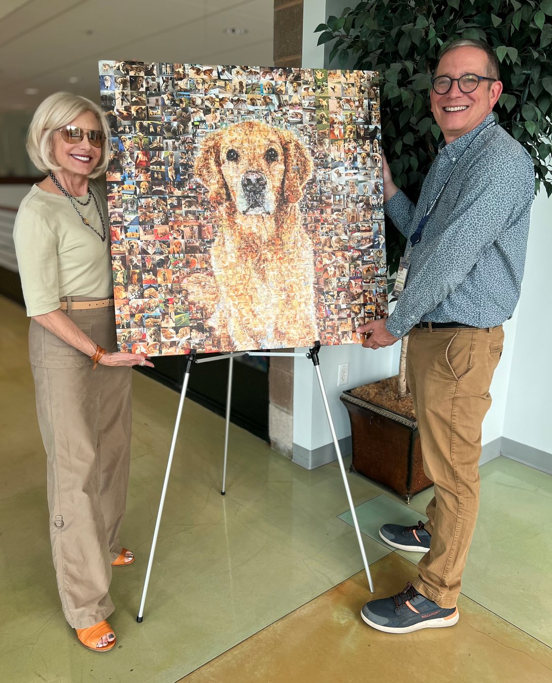 Anne Marie and Dr. Michael Kent standing either side of Winston&rsquo;s mosaic portrait on an easel at UC Davis.